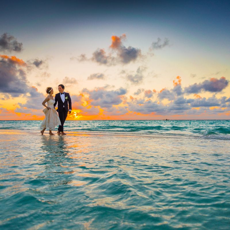 Sara and Tom standing together by the sea